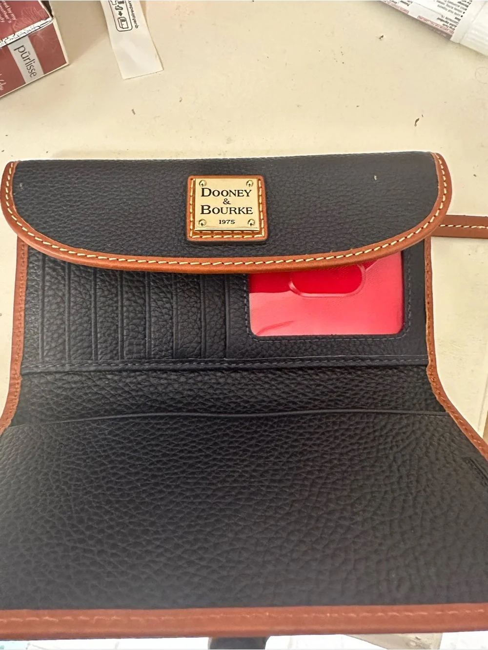 Dooney & Bourke Black Wallet with Brown Trim and Gold Plaque